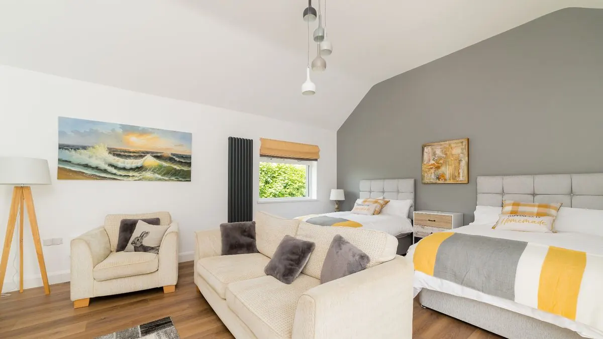 Twin bedroom with sofa seating area